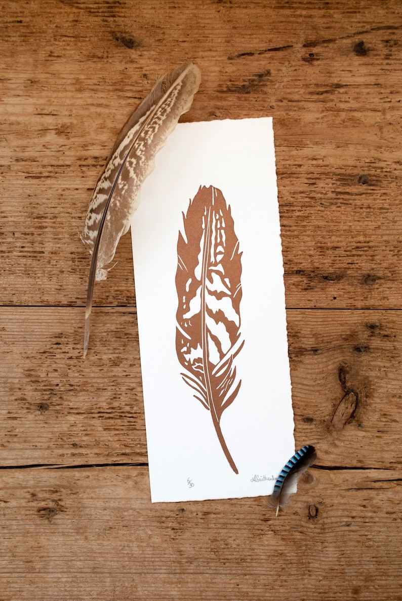 May include: A brown feather print on white paper with the number 462 and the artist's signature "Albatrosk".