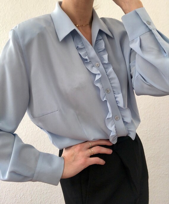 Beautiful vintage blouse in light blue with ruffle