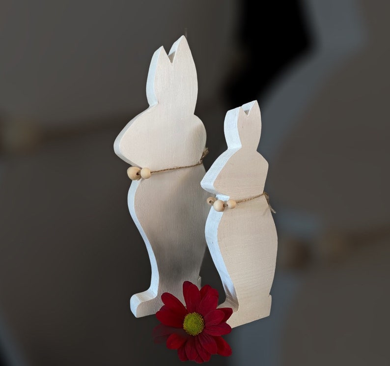Two Bunnies Handcrafted From Hardwood Available In Several Colours.