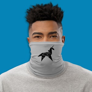 May include: A grey neck gaiter with a black origami unicorn design.