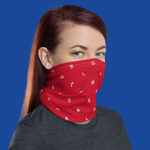 May include: A red face mask with a white pattern of Japanese characters. The mask is made of a soft, breathable fabric and is designed to be comfortable to wear.