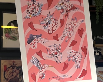 May include: A pink and white print with a variety of tattoo designs including a skull, a dragon, a hummingbird, a spider, a frog, a horse, and a panther. The print has a pink background with white hearts and wavy lines. The print is signed "Holly Rebecca Tattoo".