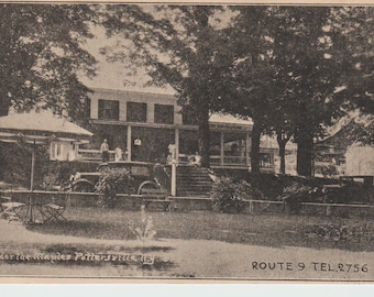 May include: A black and white vintage postcard showing a large house with a porch and a sign that reads "Under the Maples Pottersville, N.J." and "ROUTE 9 TEL. 2756".