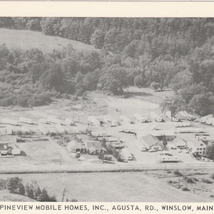 May include: A monochrome aerial photograph of Pineview Mobile Homes, Inc. in Augusta, Maine. The image depicts a community of mobile homes and buildings surrounded by trees and fields. The text at the bottom reads "PINEVIEW MOBILE HOMES, INC., AGUSTA, RD., WINSLOW, MAINE."