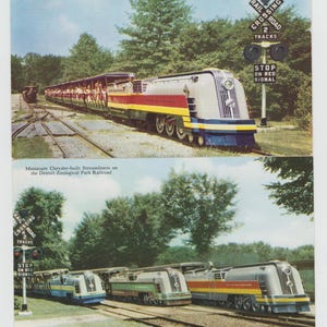 May include: Two vintage postcards featuring miniature train sets. The top postcard shows a single silver, red, and yellow train with the text "Miniature Streamliner on the Detroit Zoological Park Railroad." The bottom postcard shows three trains, one silver, one green, and one red and yellow, with the text "Miniature Chrysler-built Streamliners on the Detroit Zoological Park Railroad."