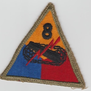 May include: A triangular patch with a tan border. The patch is divided into sections of blue, red, and orange. A black tank and red lightning bolts are in the center. The number 8 is at the top.