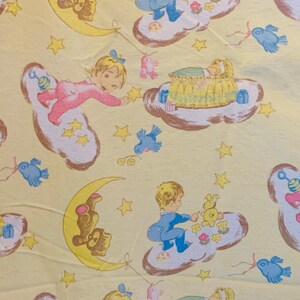 May include: A yellow fabric with a repeating pattern of children playing on clouds. The children are dressed in blue and pink pajamas. There are stars, moons, and birds on the fabric.