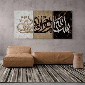 May include: Three canvas prints with Arabic calligraphy on a marble background. The prints are in black, white, and gold.