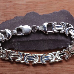 A stunning extra chunky Byzantine bracelet in a flat design. Stylish, bold and contemporary.

Handmade Sterling Silver 925

10.5mm wide.