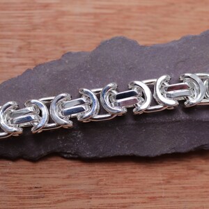 A stunning extra chunky Byzantine bracelet in a flat design. Stylish, bold and contemporary.

Handmade Sterling Silver 925

10.5mm wide.