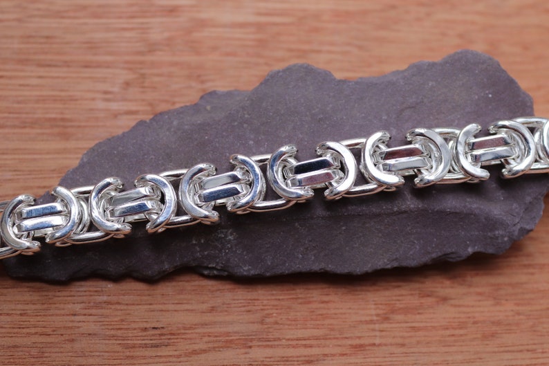 A stunning extra chunky Byzantine bracelet in a flat design. Stylish, bold and contemporary.

Handmade Sterling Silver 925

10.5mm wide.