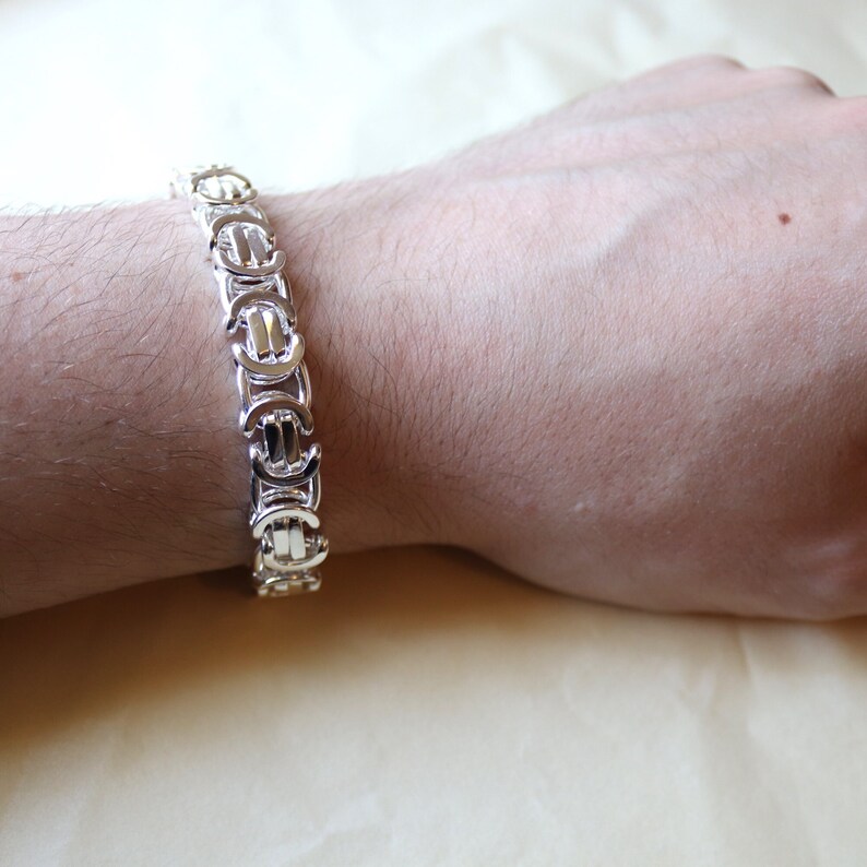A stunning extra chunky Byzantine bracelet in a flat design. Stylish, bold and contemporary.
modelled on a mans wrist

Handmade Sterling Silver 925

10.5mm wide.
