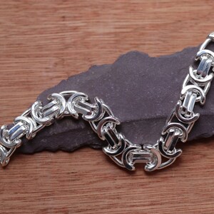 A stunning extra chunky Byzantine bracelet in a flat design. Stylish, bold and contemporary.

Handmade Sterling Silver 925

10.5mm wide.