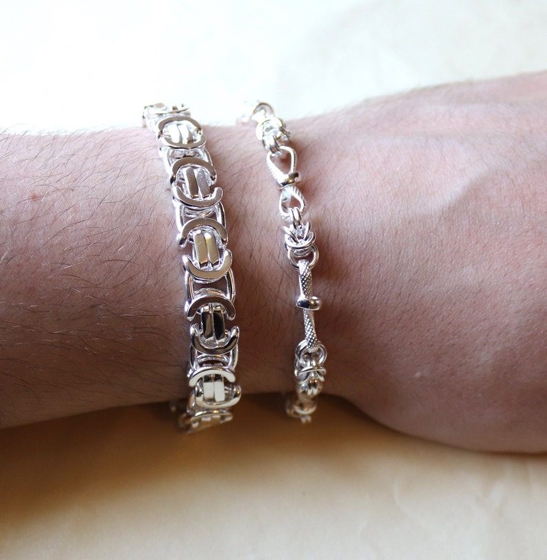 A stunning extra chunky Byzantine bracelet in a flat design. Stylish, bold and contemporary.
modelled on a mans hand

Handmade Sterling Silver 925

10.5mm wide.
