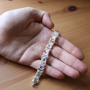 A stunning extra chunky Byzantine bracelet in a flat design. Stylish, bold and contemporary.
modelled on a mans hand

Handmade Sterling Silver 925

10.5mm wide.