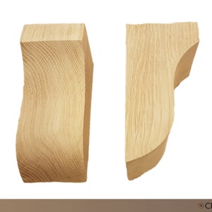 May include: Two wooden corbels, type B, in a light wood tone. The corbels are shaped like a curved bracket, with a flat top and a rounded bottom.