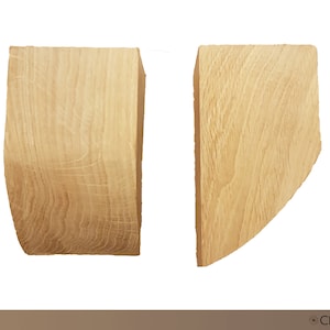 May include: Two wooden corbels, one with a curved edge and one with a straight edge. The corbels are made of light-colored wood with a natural grain pattern.  Corbels Type A.
