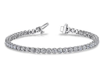 May include: A silver tennis bracelet with a row of round, clear diamonds.