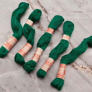 May include: Six spools of green embroidery floss with red and white labels that read "Спутник" in Cyrillic lettering.