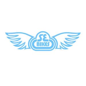 May include: A light blue decal featuring a central emblem with the text SE BIKES enclosed in a rounded shape, flanked by two stylized wings extending outward on both sides. The design is presented in a solid light blue color on a white background.