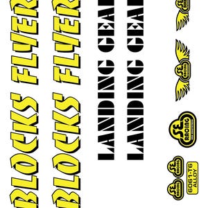 May include: A sheet of stickers with various designs and text. The words "BLOCKS FLYER" are in yellow with a black outline. "LANDING GEAR" is in black. Several SE Racing logos are also present, along with "6061-T6 ALLOY".
