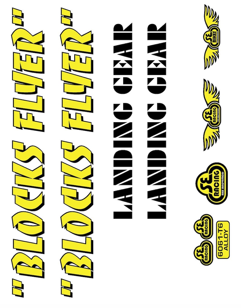 May include: A sheet of stickers with various designs and text. The words "BLOCKS FLYER" are in yellow with a black outline. "LANDING GEAR" is in black. Several SE Racing logos are also present, along with "6061-T6 ALLOY".