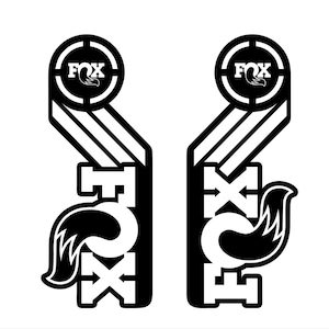 May include: Black and white graphic design featuring the word "FOX" in a circle with a target symbol. The graphic is repeated twice, with a stylized fox tail extending from the bottom of each graphic.