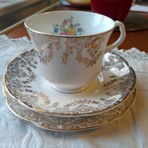 1950&#39;s Pretty Bone China Trio. Delicate Floral Bouquet Design with Intricate Gold Filigree Gilding. Made by Staffordshire Potteries. In VCG