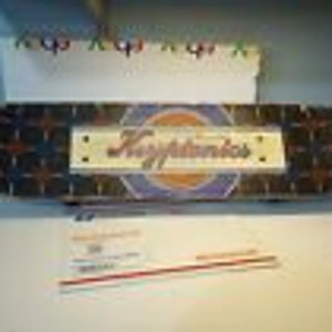 May include: A black and blue skateboard deck with a white star pattern and the word "Kruppendorf" printed in a white circle.