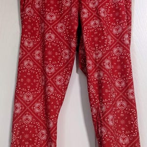 May include: Red leggings with a white paisley pattern.