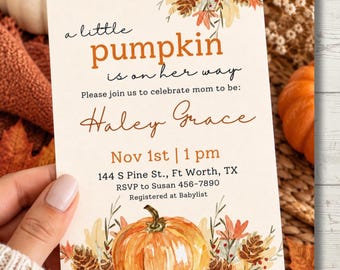 May include: A rectangular baby shower invitation card featuring watercolor illustrations of pumpkins, pinecones, and autumn leaves. The text reads: a little pumpkin is on her way, Please join us to celebrate mom to be: Haley Grace, Nov 1st | 1 pm, 144 S Pine St., Ft Worth, TX, RSVP to Susan 456-7890, Registered at Babylist.