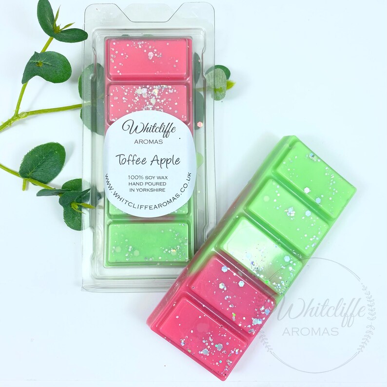May include: Two wax melts, one green and one pink, with a white label that says "Whitcliffe Aromas Toffee Apple 100% Soy Wax Hand Poured in Yorkshire www.whitcliffe aromas.co.uk"