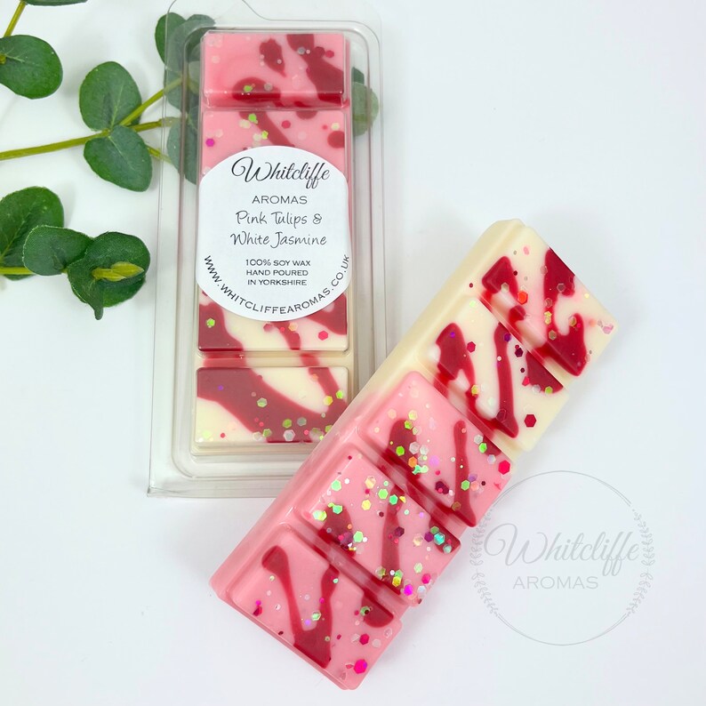 May include: A pink and white soy wax melt bar with a pink tulip and white jasmine scent. The bar is hand-poured in Yorkshire, England. The label reads "Whitcliffe Aromas".