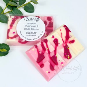 May include: A pink and white soy wax melt with a pink and white swirl design. The melt is labeled "Whitcliffe Aromas Pink Tulips & White Jasmine 100% Soy Wax Hand Poured in Yorkshire www.whitcliffe aromas.co.uk"