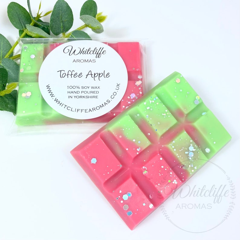 May include: A green and pink soy wax melt with glitter, labeled "Whitcliffe Aromas Toffee Apple 100% Soy Wax Hand Poured in Yorkshire www.whitcliffe aromas.co.uk"