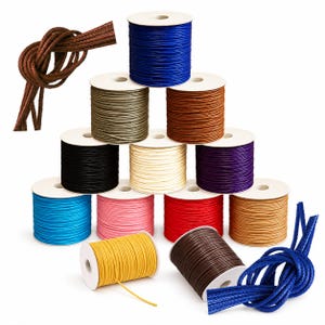 May include: A collection of twelve spools of braided cord in various colors including blue, olive green, brown, black, cream, purple, light blue, pink, red, tan, yellow, and dark brown, with loose knotted cord samples in brown and blue.
