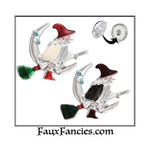 May include: Two silver-toned witch charms with red hats, green brooms, and blue gemstones. The witch on the left has a white face and the witch on the right has a black face. The charms are attached to a silver-toned snap button.