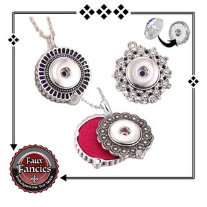 May include: Three silver charm necklaces with a snap button pendant. The pendants are decorated with different designs, including a purple and silver design, a floral design, and a red and silver design. The necklaces are on a white background.
