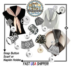 May include: A collection of silver-toned metal snap button scarf or napkin holders featuring various intricate filigree, floral, and star patterns. Each holder includes a circular snap button attachment for securing fabric, shown in use with scarves and napkins.