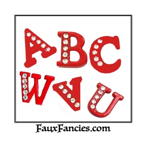 May include: Red letter charms with rhinestones, spelling out the letters ABC and WU. The charms are on a white background. FauxFancies.com is printed below the charms.