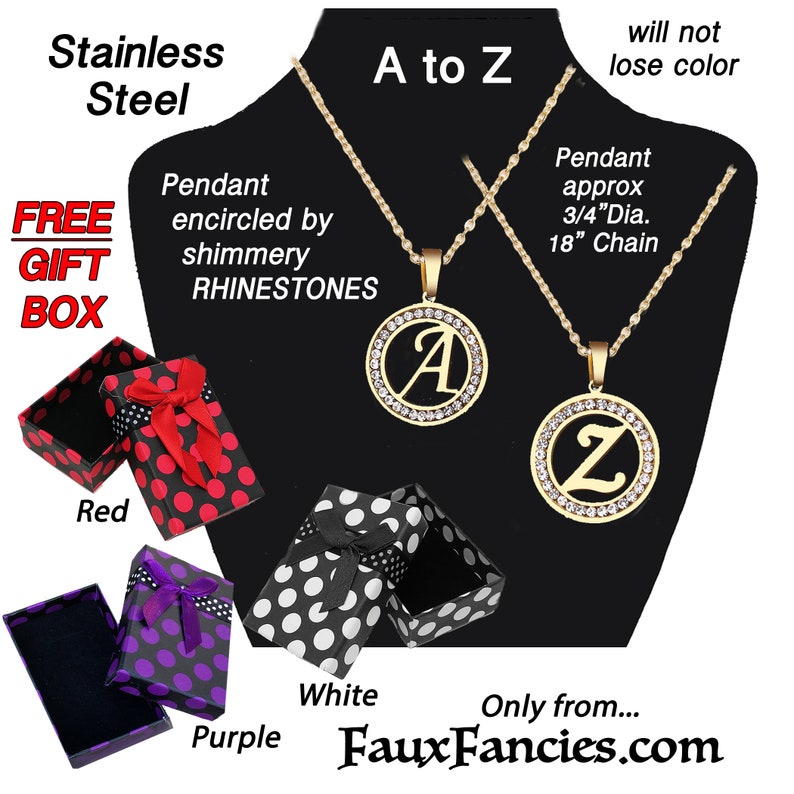 May include: Two gold-tone stainless steel necklaces featuring circular pendants with an initial letter A or Z, encircled by clear rhinestones on 18-inch chains. Includes three gift boxes in red, purple, and white with polka dot patterns.