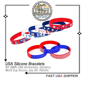 May include: A collection of red, white, and blue silicone bracelets featuring various designs including stars, stripes, the text I LOVE USA, and HAPPY 4TH OF JULY. The bracelets are arranged in two groups, showcasing patriotic themes with American flag motifs.