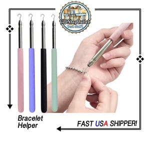 May include: A set of four bracelet helper tools in pink, purple, black, and mint green. The tools have a metal hook and handle, with the text "Bracelet Helper" below the tools. A hand is using a tool to fasten a bracelet.