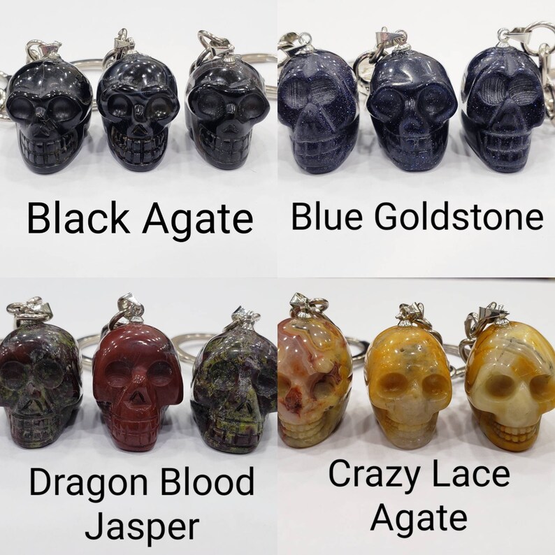 May include: Set of ten skull-shaped keychains made of various types of agate. The keychains are black agate, blue goldstone, dragon blood jasper, and crazy lace agate.