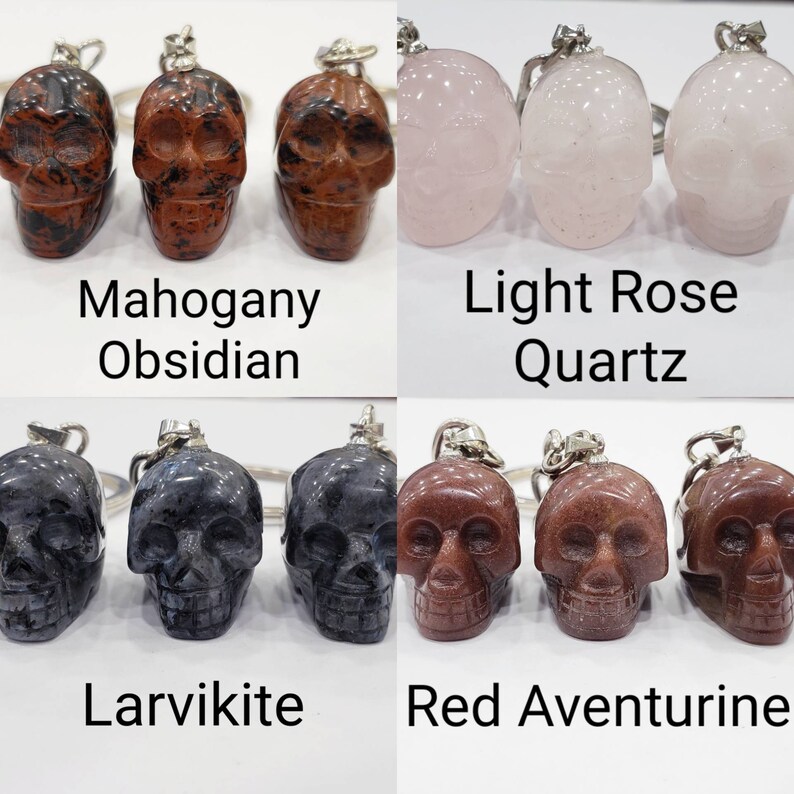 May include: Four sets of three crystal skull keychains. Each set features a different type of crystal: Mahogany Obsidian, Light Rose Quartz, Larvikite, and Red Aventurine.