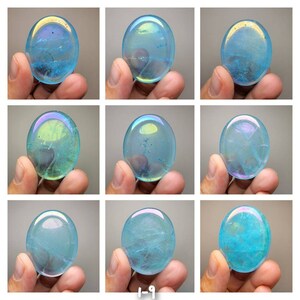 May include: Nine iridescent blue and green gemstone palm stones. The stones are smooth and polished, with a variety of patterns and textures.