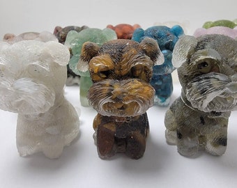 May include: A collection of miniature dog figurines, each painted in a different color, including white, green, brown, blue, and gray. The figurines are made of a translucent material, giving them a unique and whimsical look.