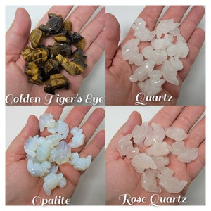 May include: Four sets of small carved animal figurines made of different types of crystals. The crystals are Golden Tiger's Eye, Quartz, Opalite, and Rose Quartz.