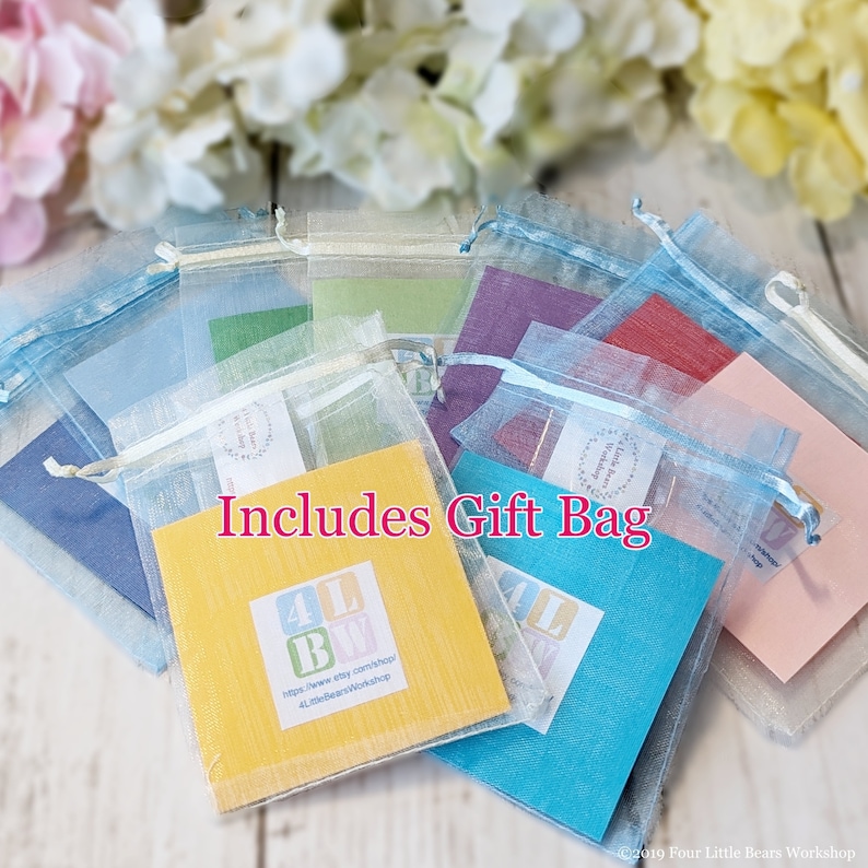 May include: Assortment of colorful organza gift bags with a small card that reads "Includes Gift Bag" and a website address for 4LittleBeans Workshop.