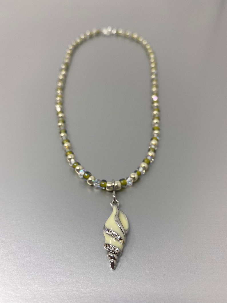 Shining Seas Necklace Sterling Silver Imitation Rhodium Plated Brass Glass Rhinestone Off White Olive Green Conch Seashell Nautical Gift